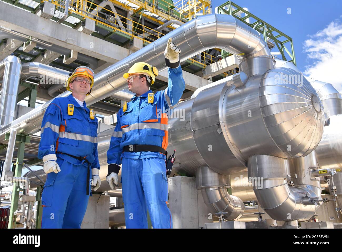 teamwork group of industrial workers in a refinery oil processing