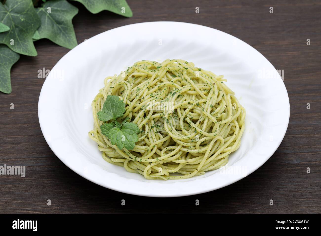 Pasta spaghetti with basil, cream and cheese on white table Stock Photo