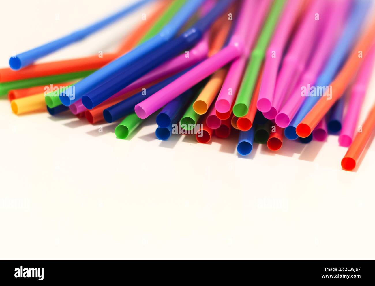 a group of colored plastic cocktail straws. Plastic and non-recyclable materials. Stock Photo