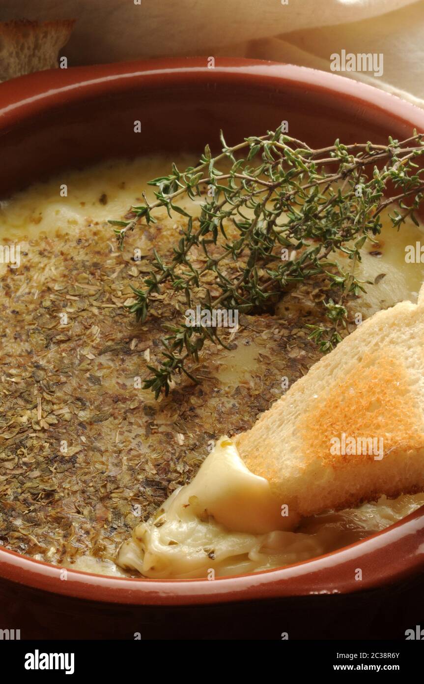 Provolone cheese melted with oregano Stock Photo Alamy