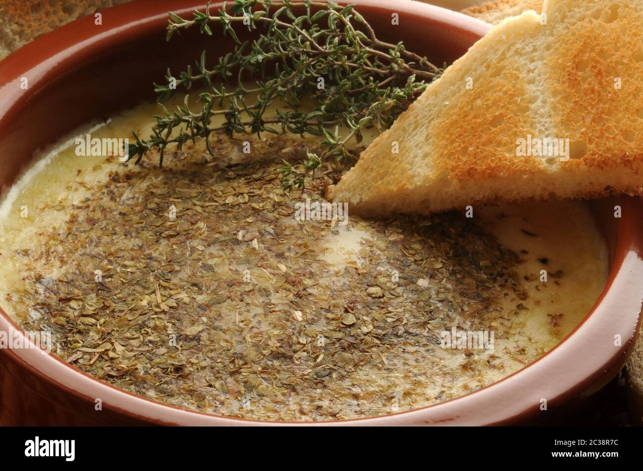 Provolone cheese melted with oregano Stock Photo Alamy