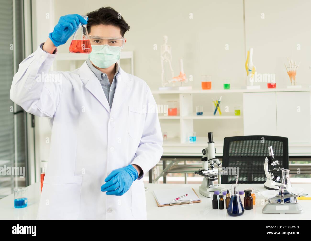 An Asian male scientist is experimenting with the search for medicine. In the lab Stock Photo