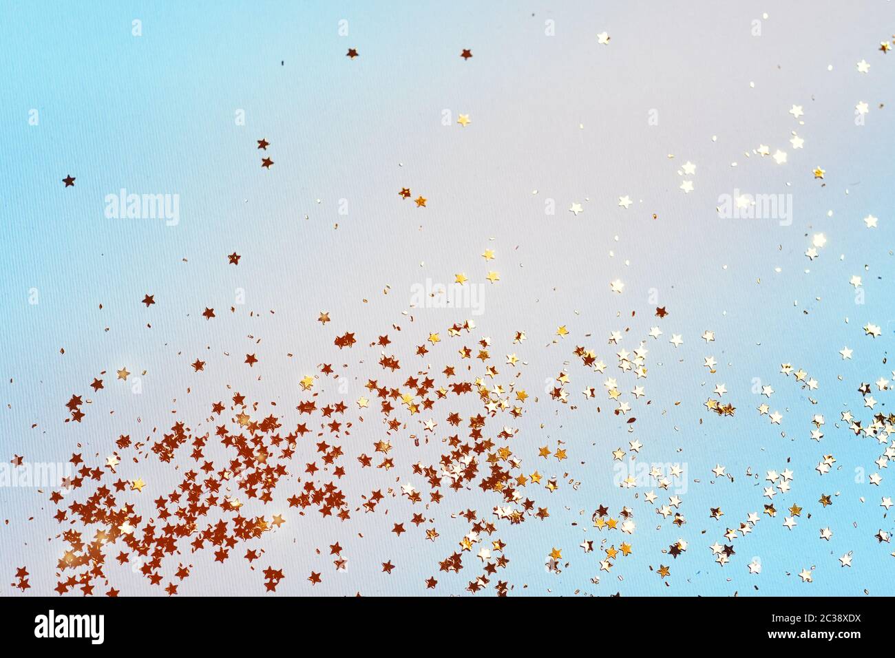 Gold stars confetti on a blue background Stock Photo - Alamy