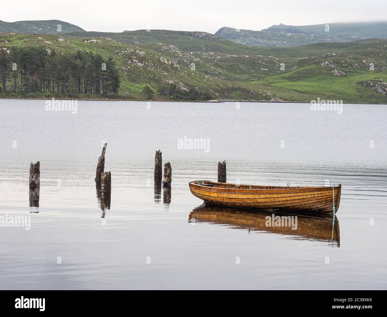 Wooden hulled boat moored at the old jetty Tollie Bay, Loch Maree ...