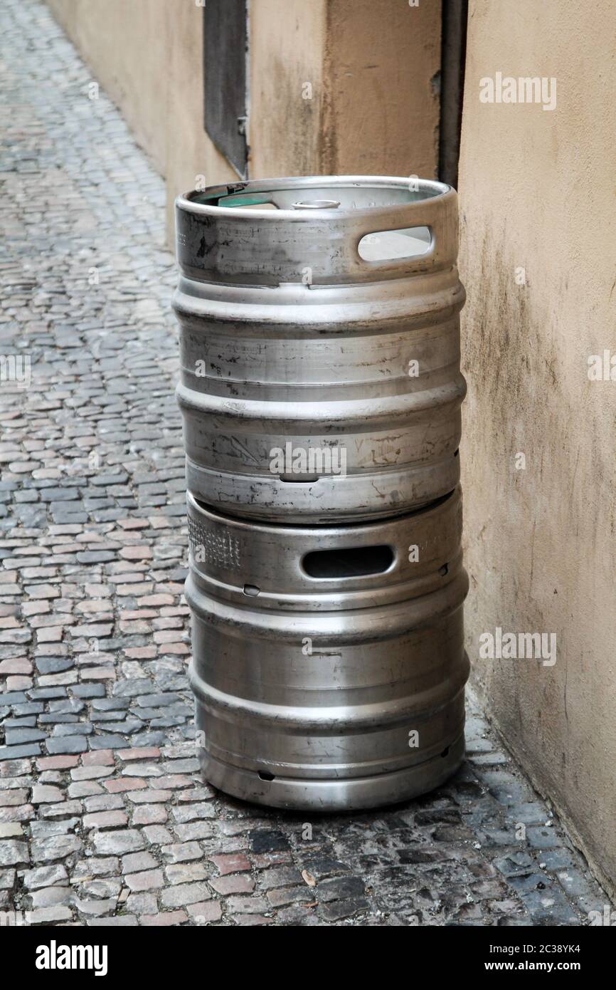 two metal drums for the transport of beer stand on the footpath Stock Photo
