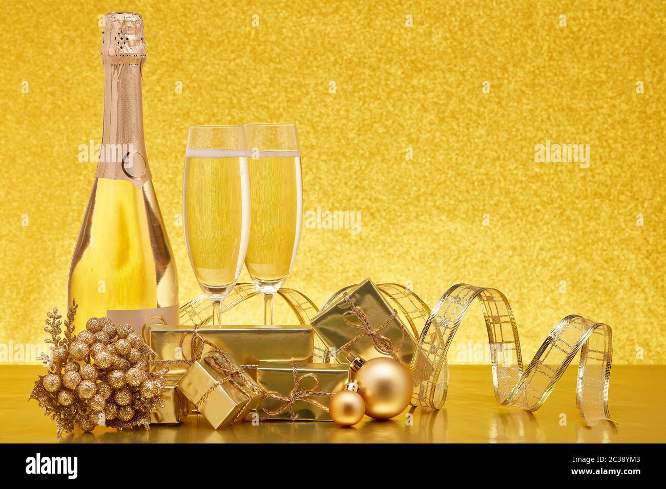 Golden Christmas ornaments, gift boxes, champagne bottle and full ...