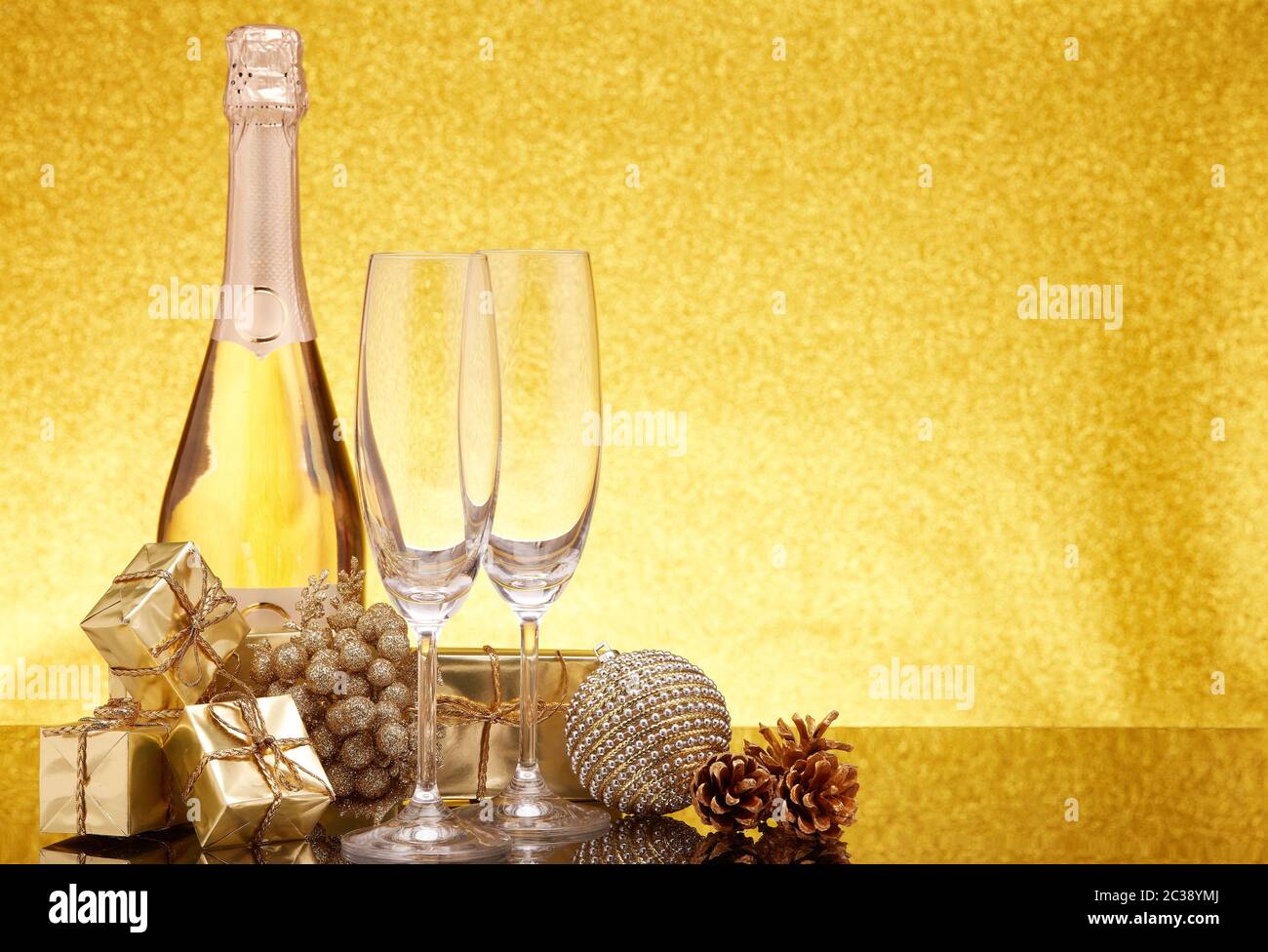 Golden Christmas ornaments, gift boxes, champagne bottle and empty ...