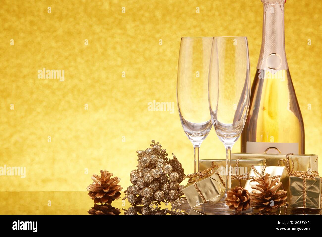 Golden Christmas ornaments, gift boxes, champagne bottle and empty ...