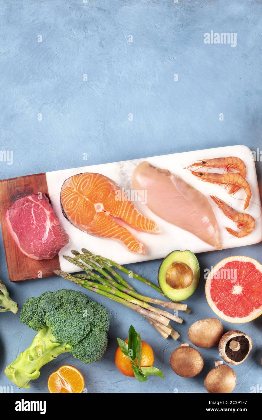 Food overhead flat lay shot. Main proteins, meat, fish, poultry and seafood, with vegetables and fruit, shot from the top with a Stock Photo