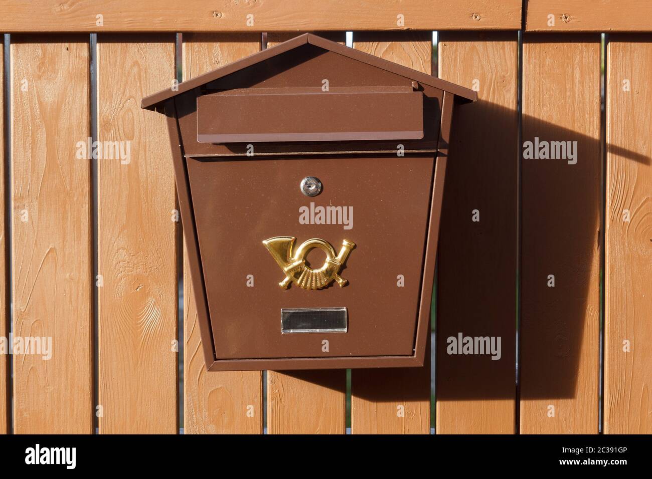 Brown metalic mailbox on brown wood Fence Stock Photo - Alamy