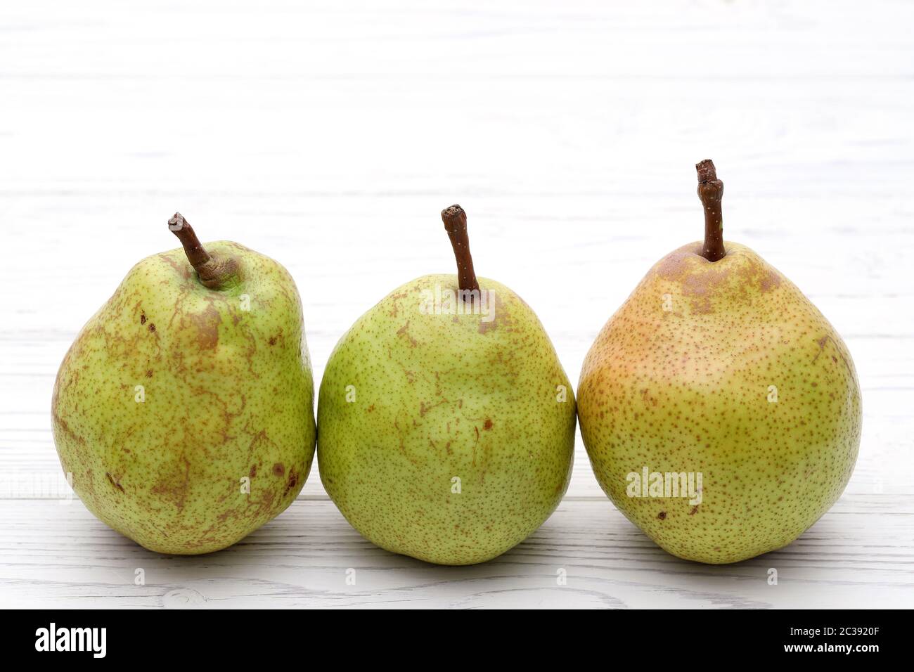 Green ripe pear on a white table background. in studio shot Stock Photo