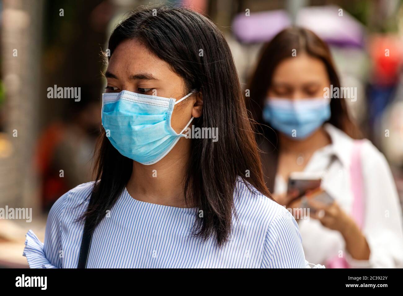 Office worker wearing face mask during Covid 19 pandemic, Bangkok, Thailand Stock Photo