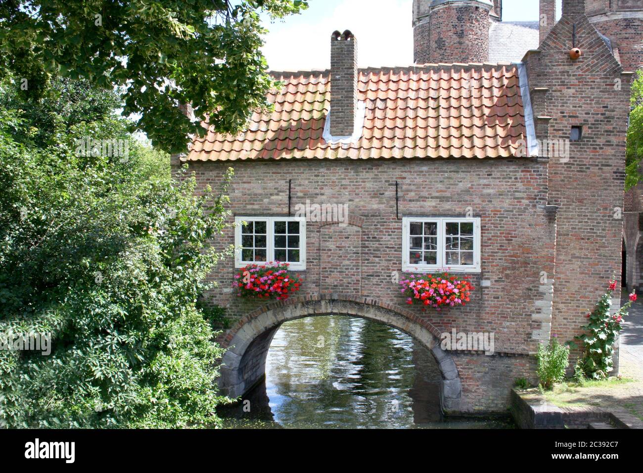 Romantic house with archway over a watercourse Stock Photo