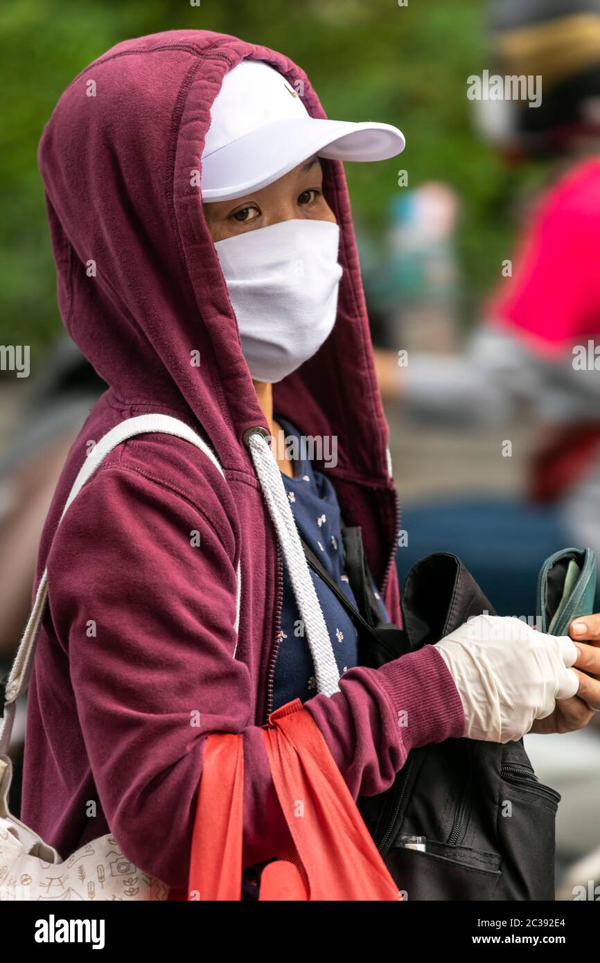 Girl wearing hoodie and face mask during Covid 19 pandemic Bangkok Thailand Stock Photo Alamy