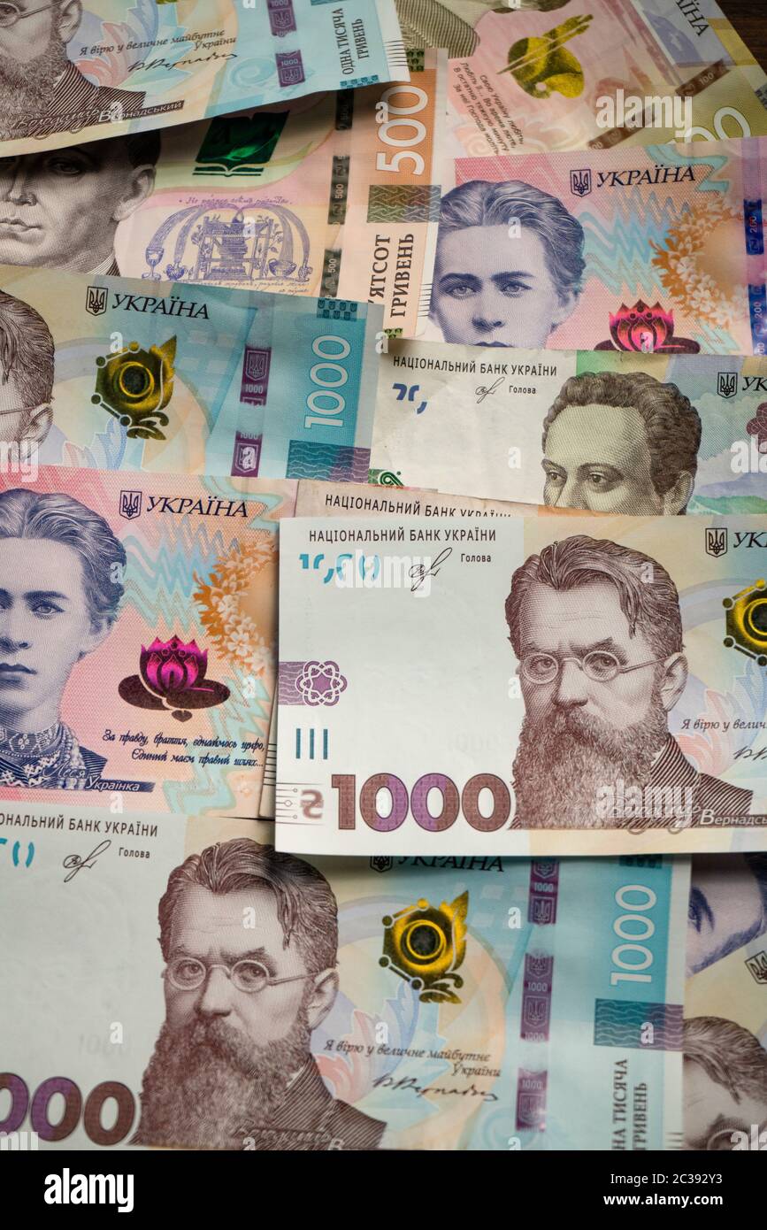 Ukrainian money pattern from new banknote. Paper hryvnias different face value with 1000 hryvnias on the top. Background or texture. Vertical format Stock Photo