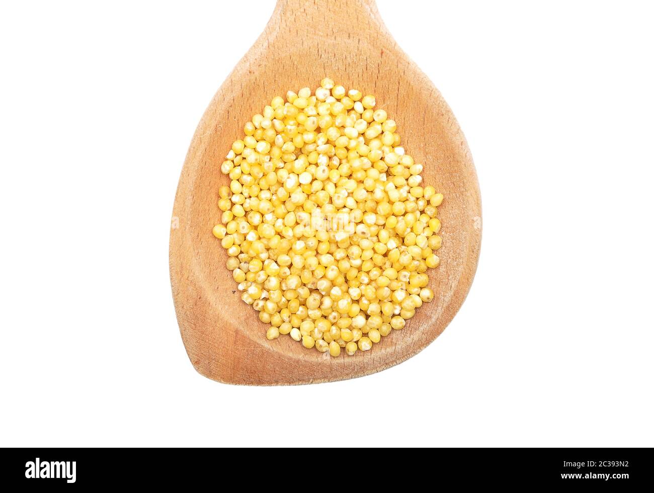 Raw millet on wooden spoon and white background Stock Photo