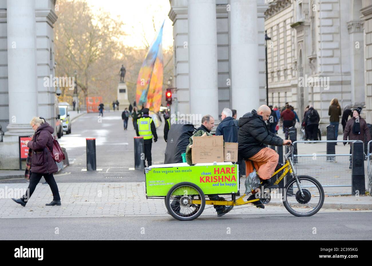 London, England, UK. Man riding a Hare Krishna bike in Whitehall delivering free vegetarian meals Stock Photo