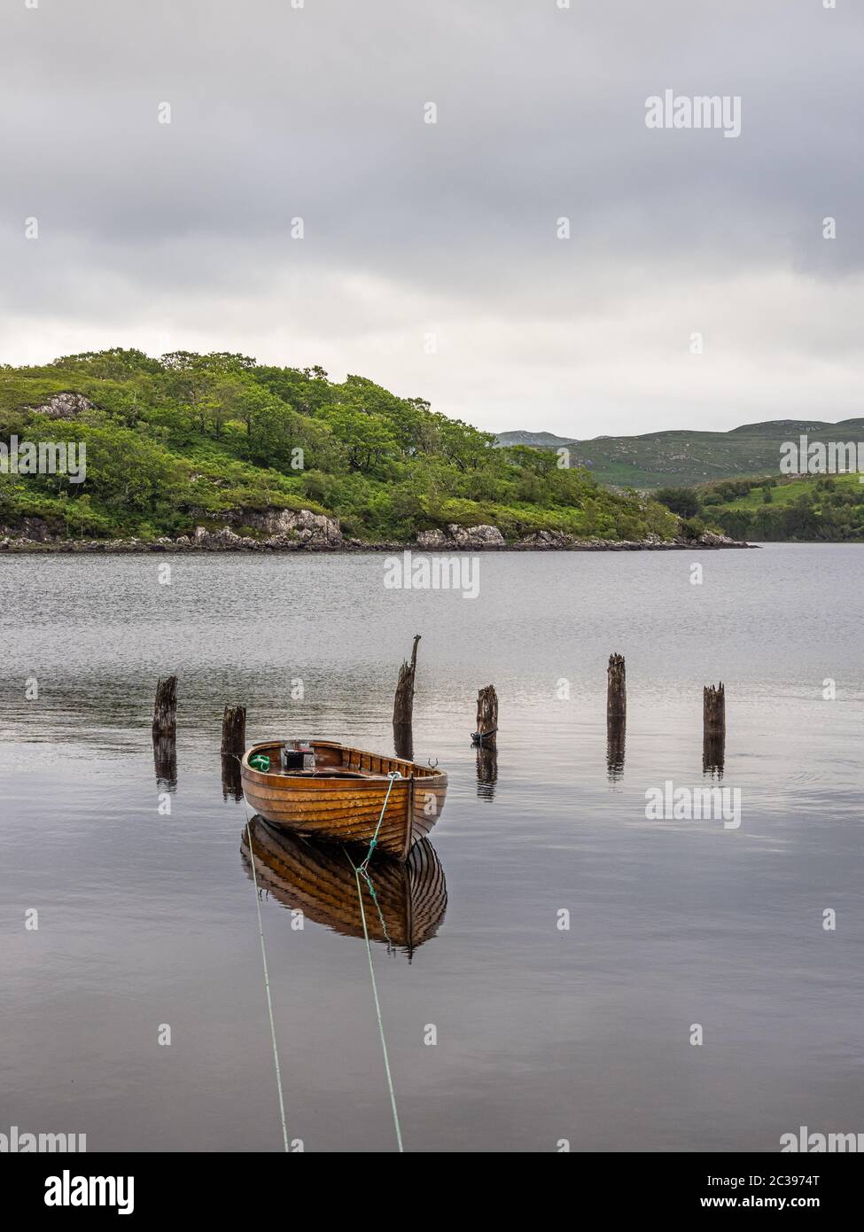 Wooden hulled boat moored at the old jetty Tollie Bay, Loch Maree