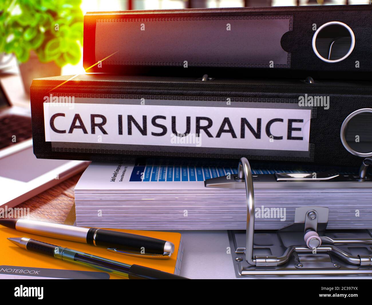 Black Ring Binder with Inscription Car Insurance on Background of Working Table with Office Supplies and Laptop. Car Insurance Business Concept on Blu Stock Photo