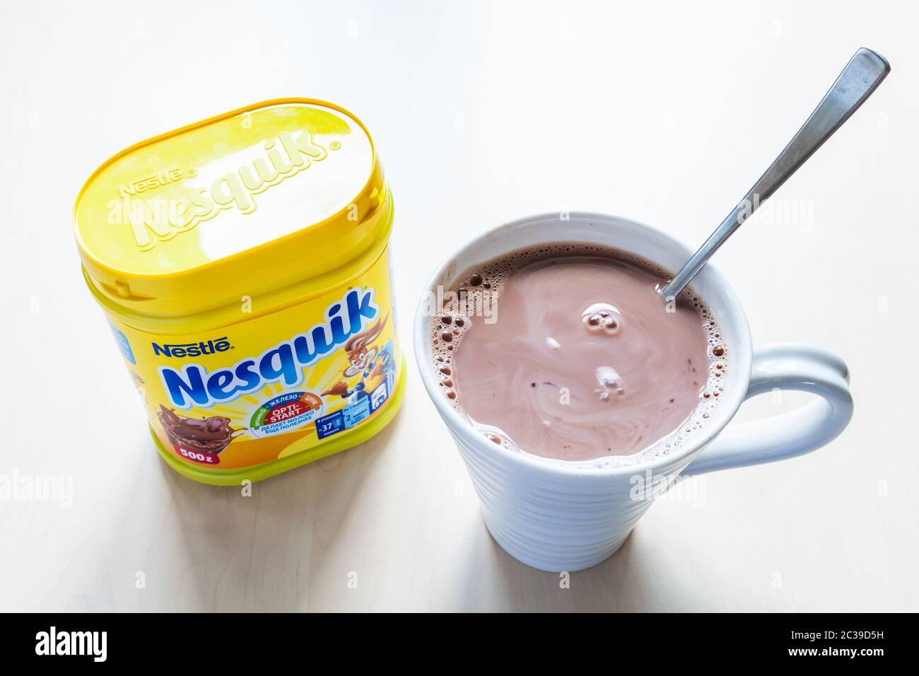 MOSCOW, RUSSIA - JUNE 16, 2020: top view of closed jar of Nesquik and mug with hot chocolate on table. Nesquik Chocolate Powder was introduced in 1948 Stock Photo