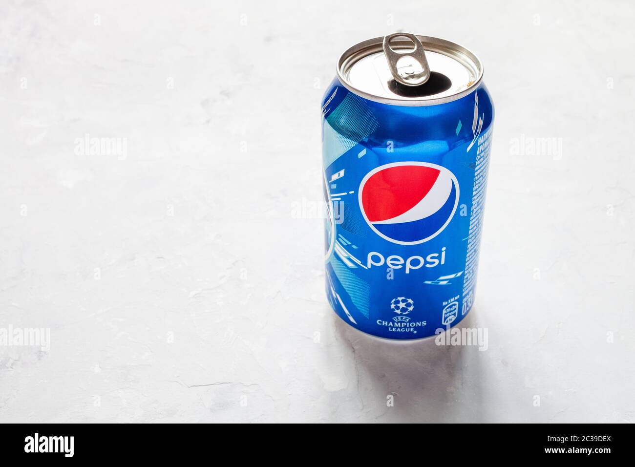MOSCOW, RUSSIA - JUNE 17, 2020: open can of Pepsi with logo of UEFA Champions League on concrete floor. Pepsi is carbonated soft drink manufactured by Stock Photo