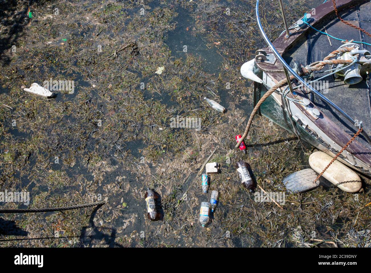 Plastic rubbish around a boat in Workington, Cumbria, UK. Stock Photo