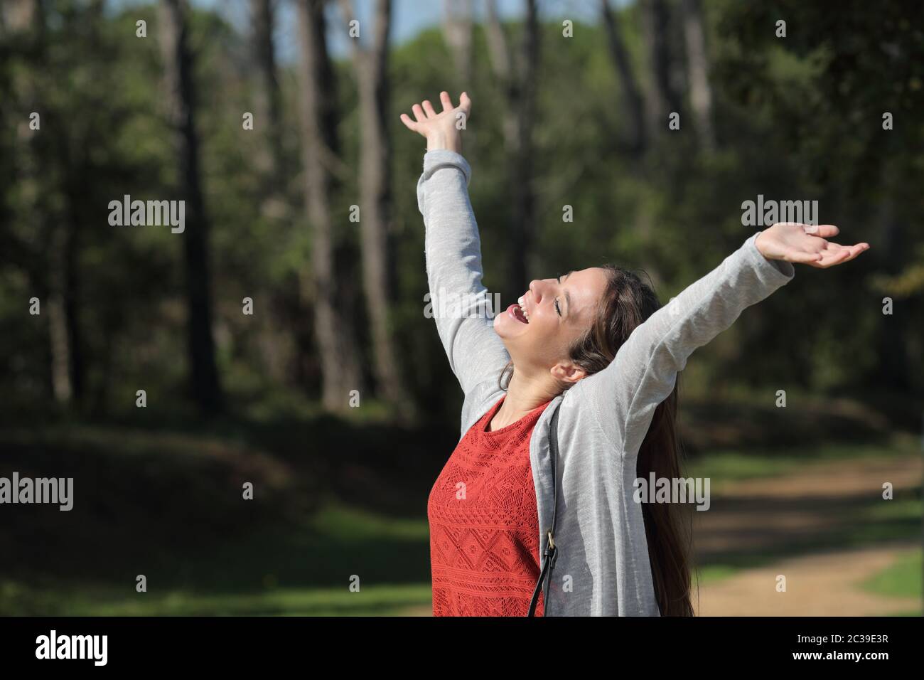 Single excited woman celebrating success raising arms and laughing in a ...