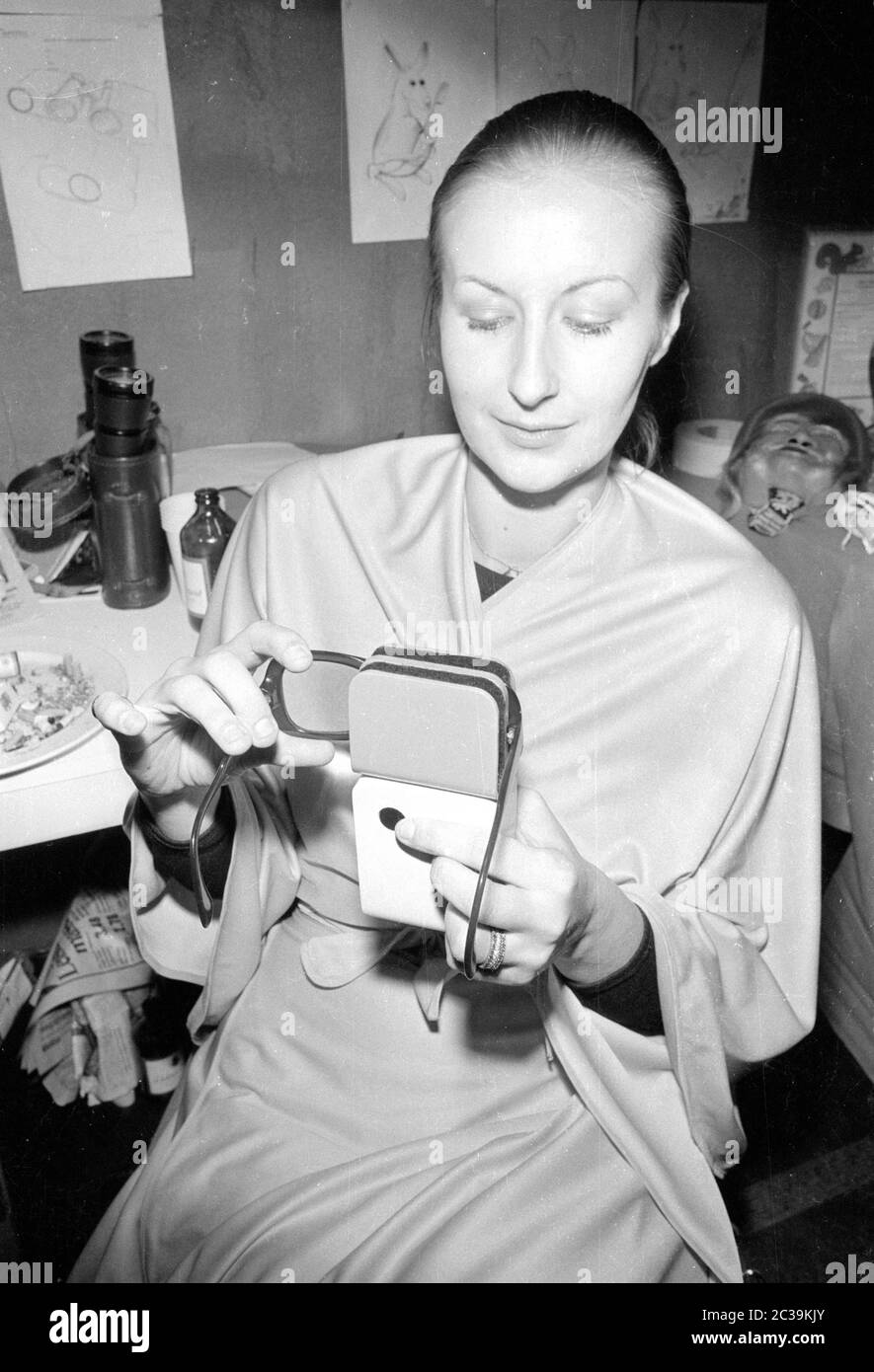 A woman shows a machine for cleaning glasses at the ' Inventor and Novelty Exhibition' in Nuremberg. It is probably an invention of Walter Thiele. Stock Photo