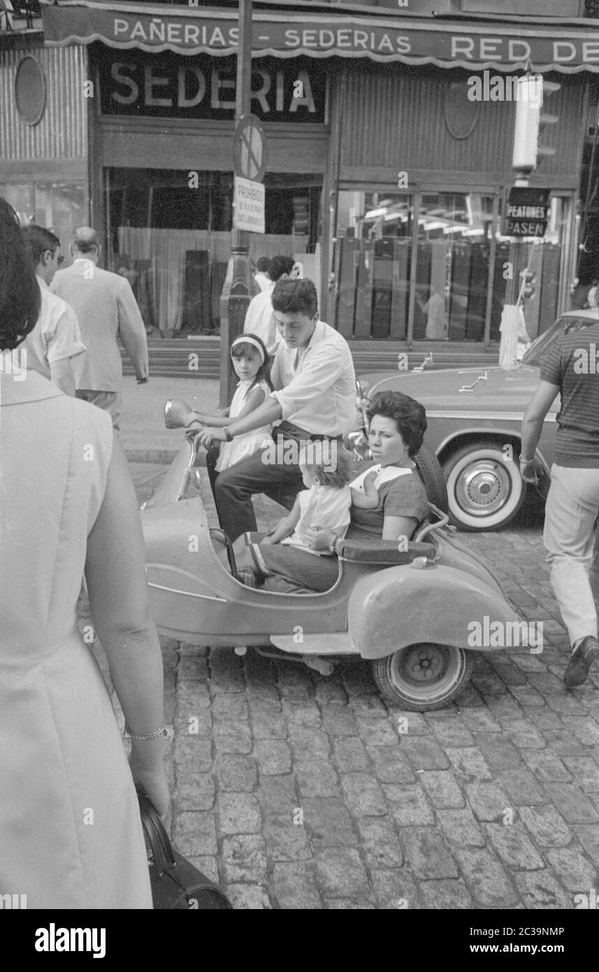 A Spanish family of four in a Vespa with sidecar in Madrid Stock Photo