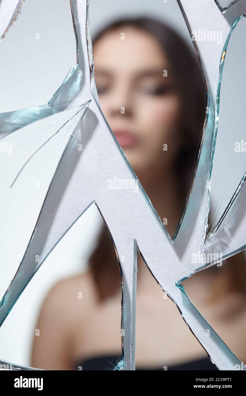 Girl Looking In A Broken Mirror High Resolution Stock Photography and