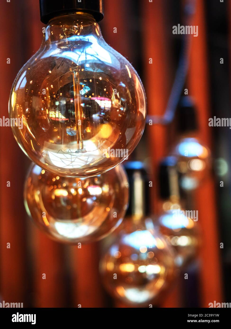 Vertical image of transparent glossy bulbs with interior reflecting in them. Stock Photo