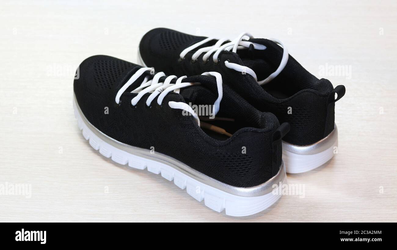 black tennis shoes with white soles