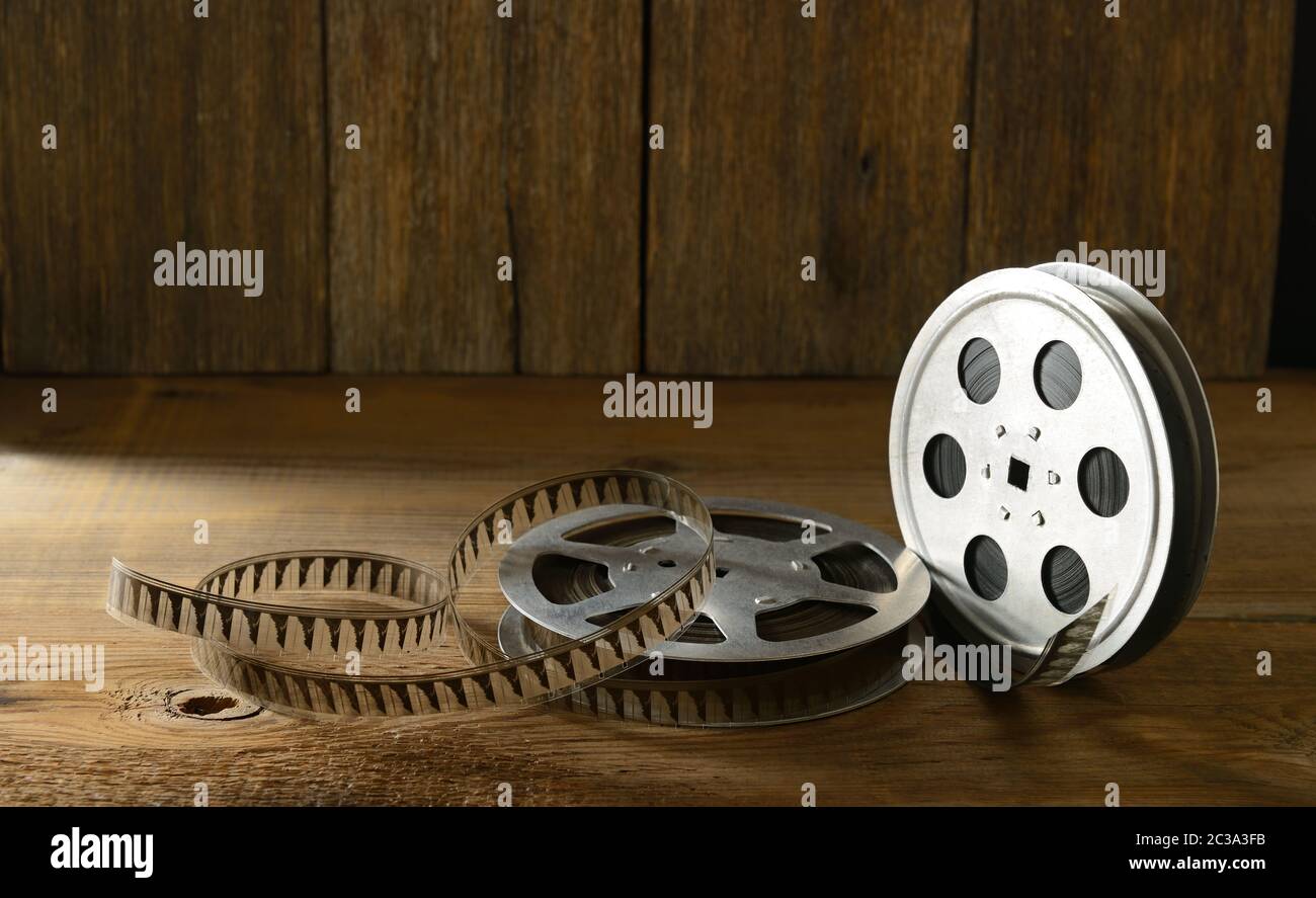 Old film strip on wooden background. Side view. Copy space. Selective focus Stock Photo