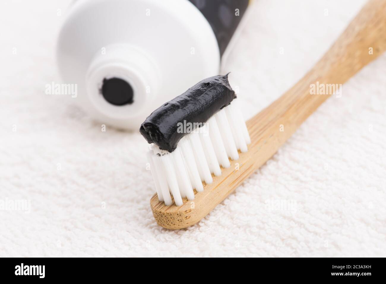 Toothbrush with black charcoal toothpaste Stock Photo