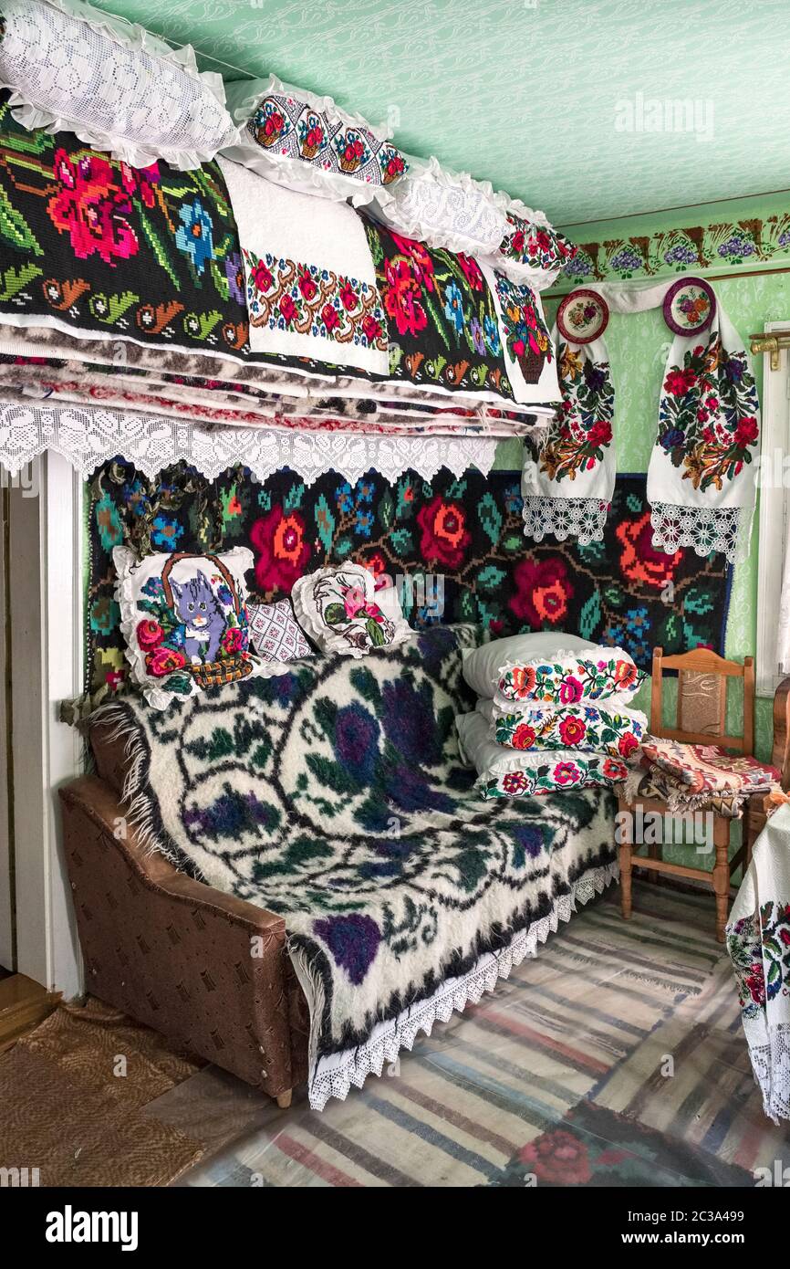 The colourful interior of a house in the village of Botiza, Maramureș, Romania. The area is known for its handwoven wool carpets and rugs Stock Photo