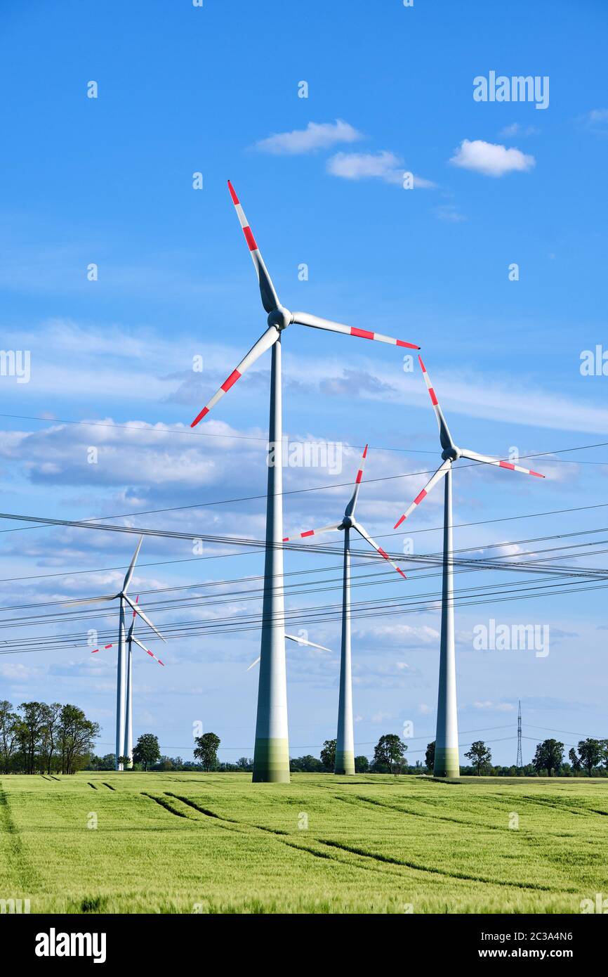 Wind power plants and overhead power lines seen in Germany Stock Photo