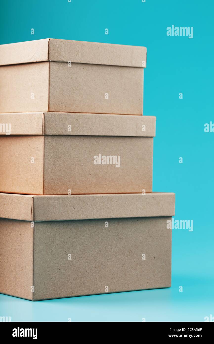 Postal cardboard boxes on a blue background close-up. Stock Photo