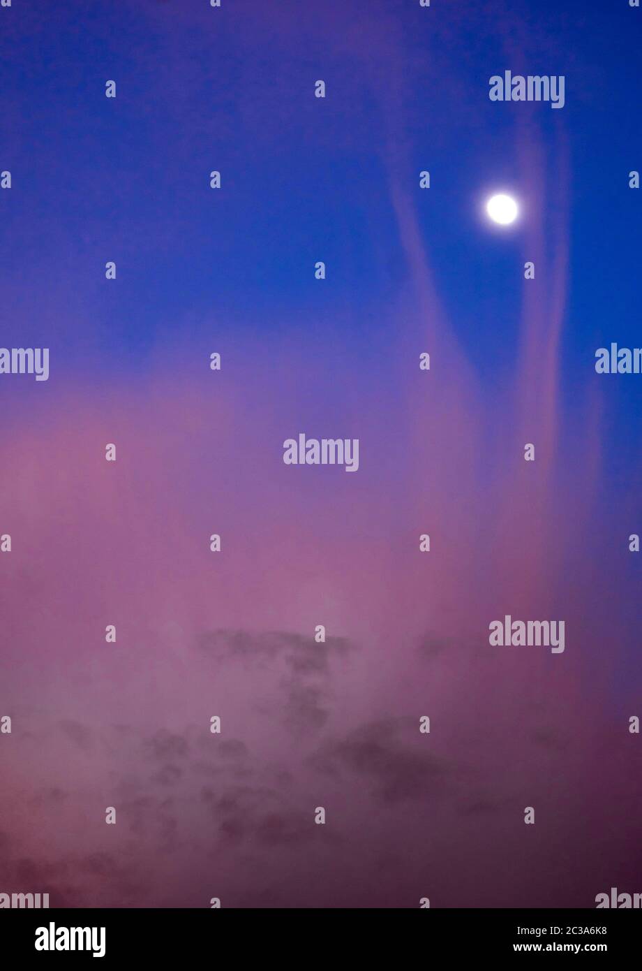 Pink clouds and moon in sunset sky Stock Photo Alamy