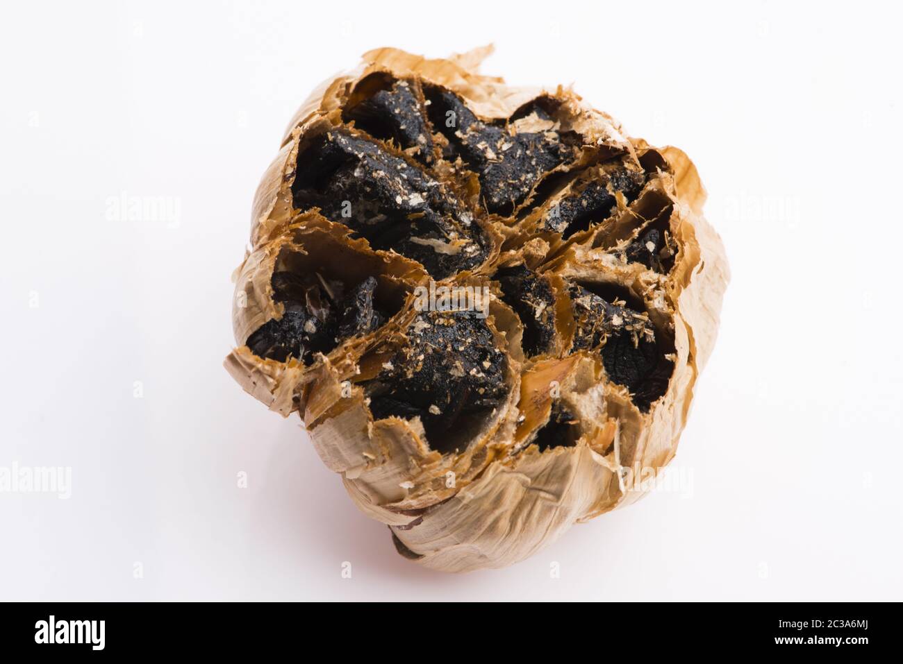 Black garlic cloves isolated on white background Stock Photo