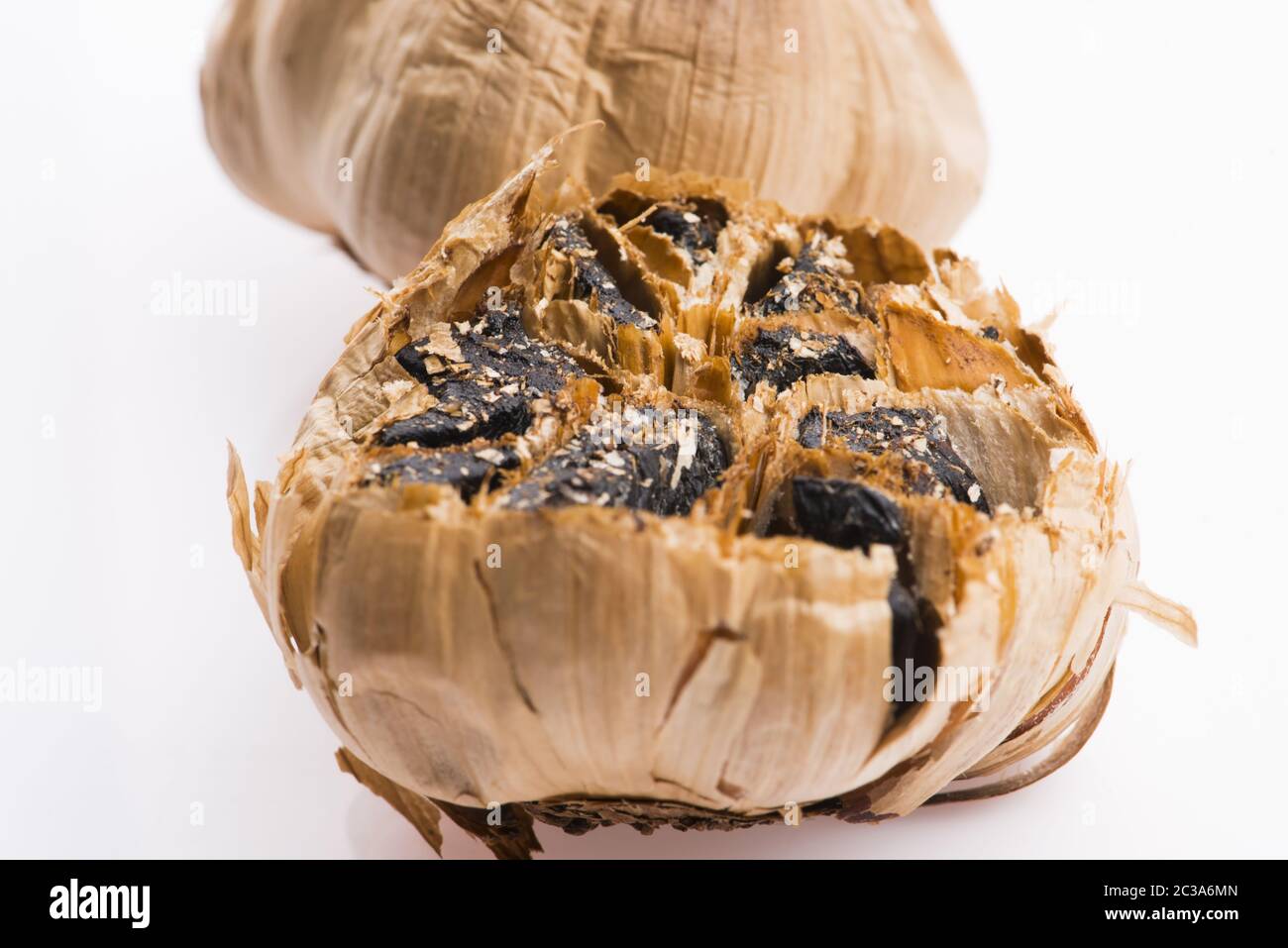 Black garlic cloves isolated on white background Stock Photo