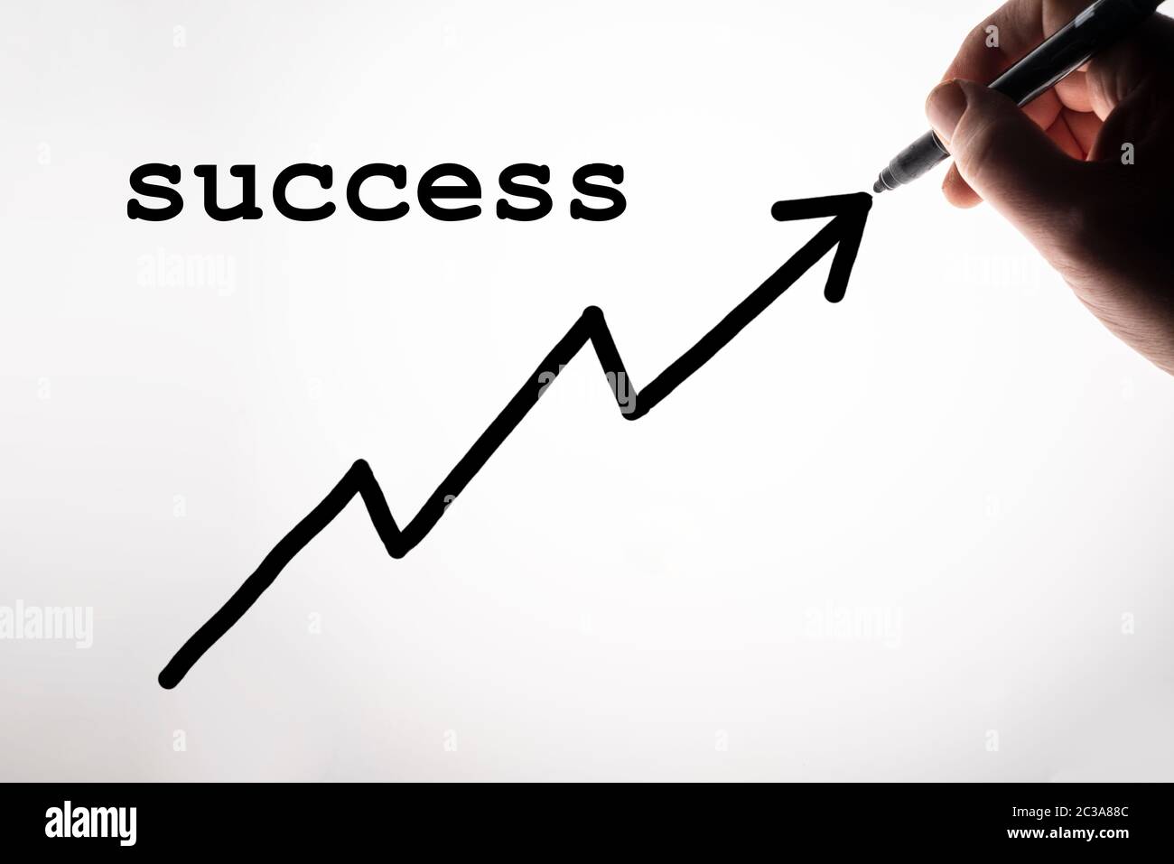 the success graph drawn on a backlit surface Stock Photo