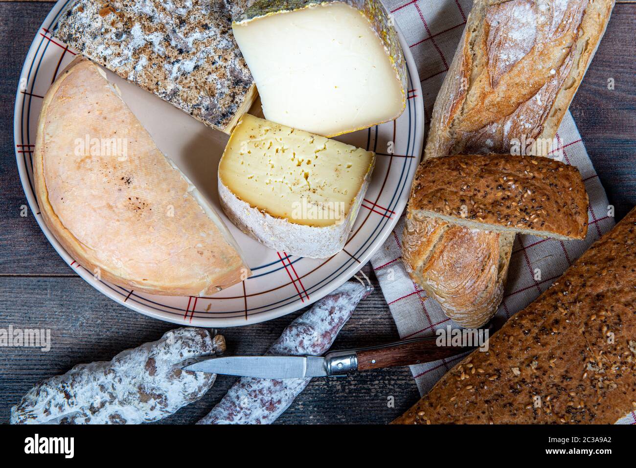 cheeses, sausage and Tomme de Savoie, Savoy, a french Alps France. Stock Photo