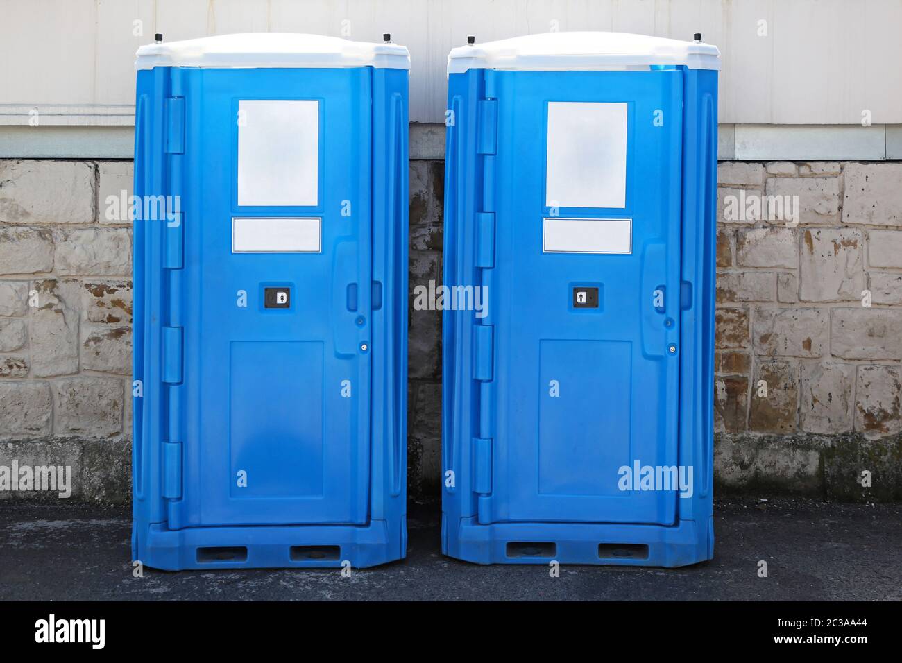 Two blue portable toilet cabins at construction site Stock Photo Alamy