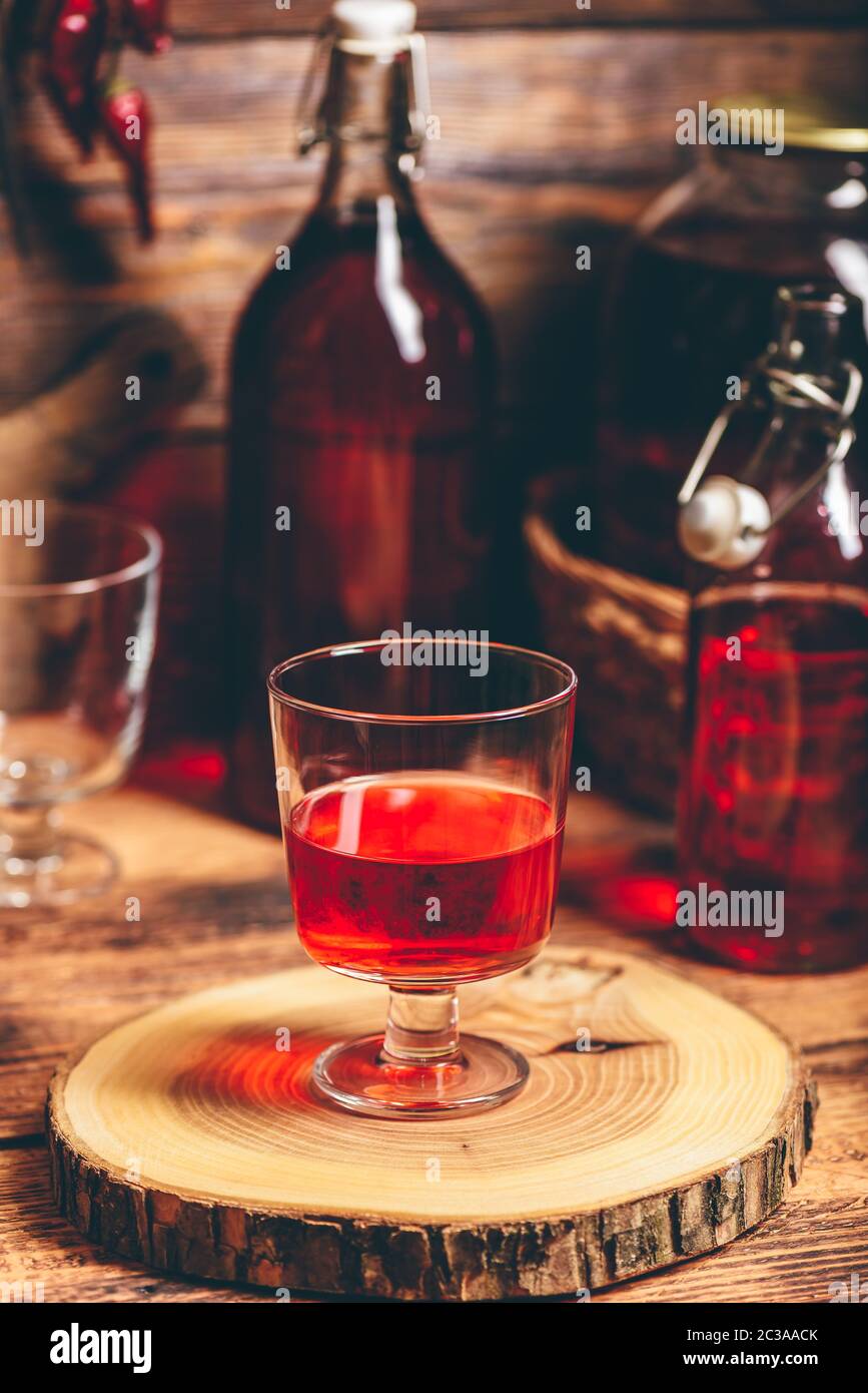 Homemade red currant liquor in a drinking glass Stock Photo
