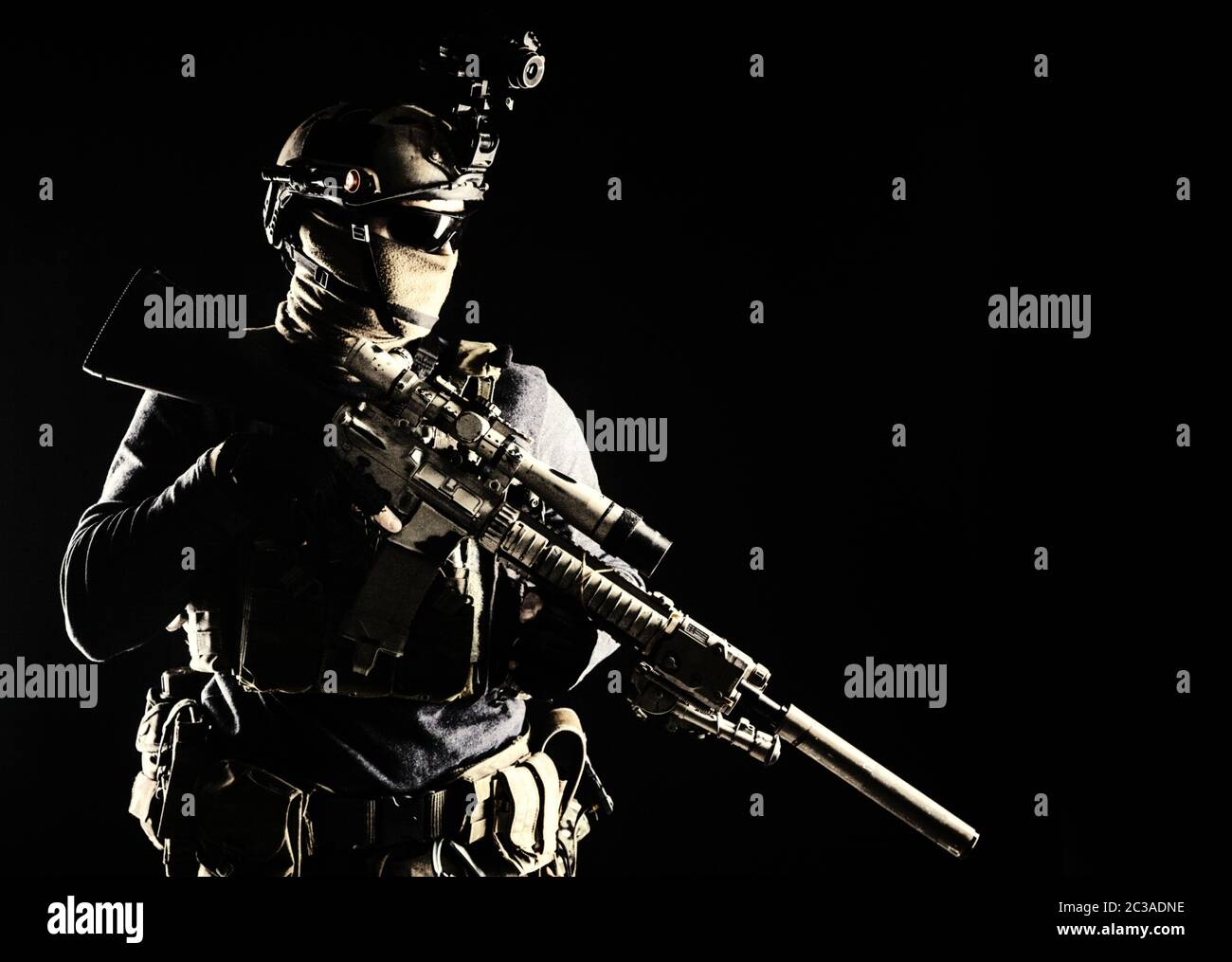 Army elite troops marksman, special operations forces sniper wearing mask and glasses, night-vision or infrared thermal imaging device on helmet, hold Stock Photo