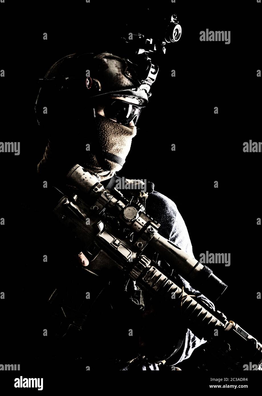 Shoulder portrait of army elite troops sniper, anti-terrorist tactical team marksman wearing helmet with thermal imager, hiding face behind mask, arme Stock Photo