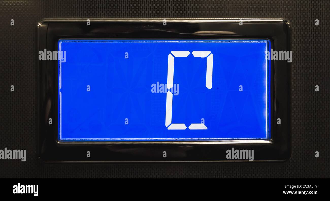 broken blue LCD display showing 0 in an elevator Stock Photo