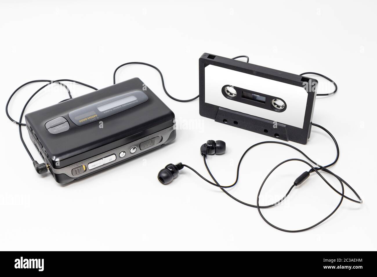 Vintage audio player. Old fashioned portable cassette player, cult object, icon and symbol of the 80s and 90s. Blank audio tape and headphones isolate Stock Photo