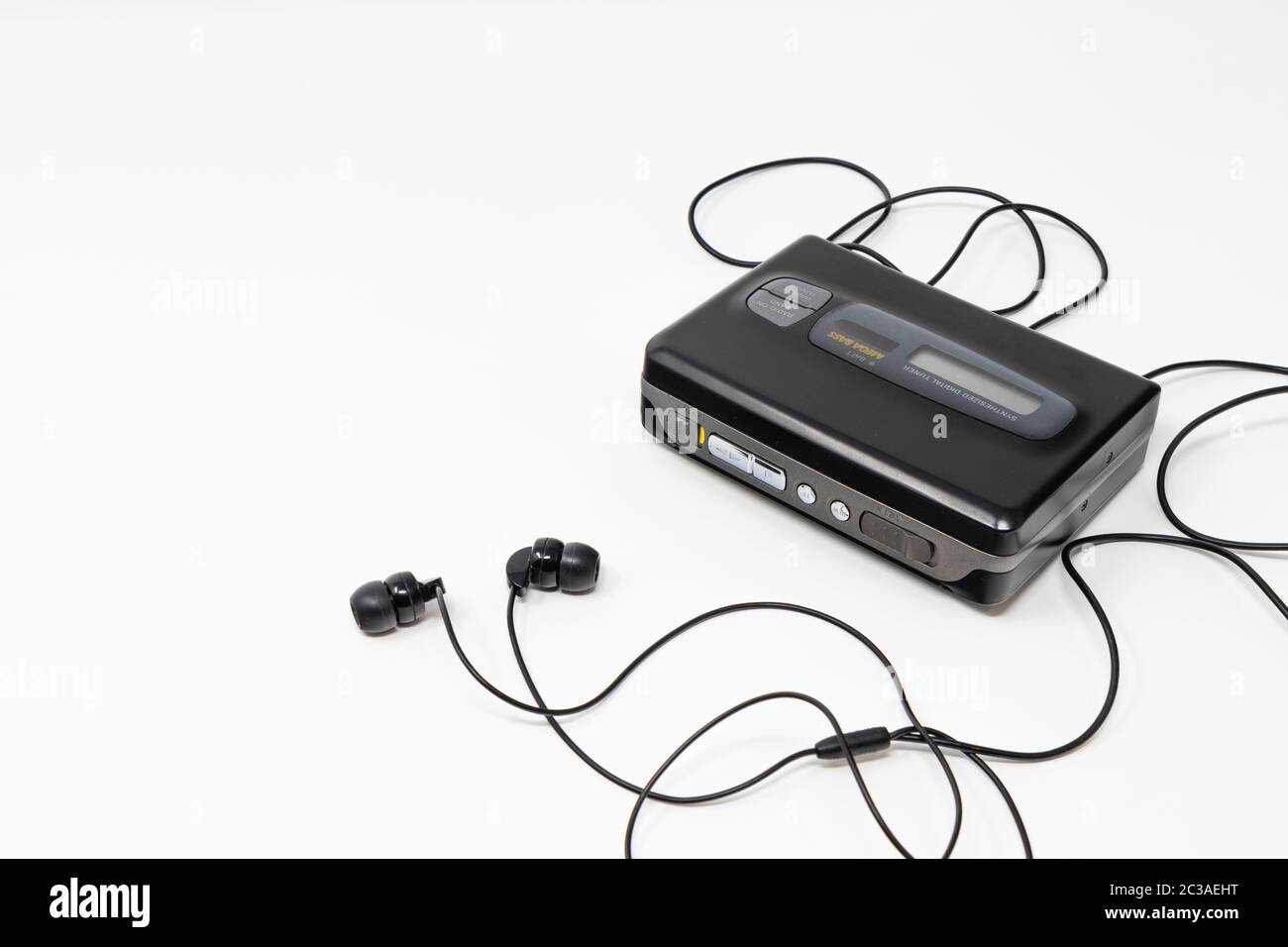 Vintage audio player. Old fashioned portable cassette player, cult object, icon and symbol of the 80s and 90s. Headphones isolated on white background Stock Photo