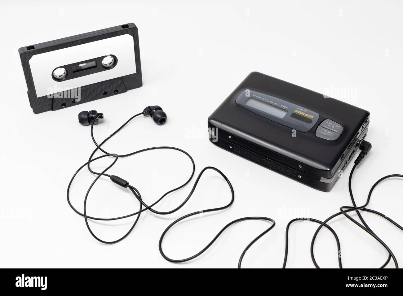 Vintage audio player. Old fashioned portable cassette player, cult object, icon and symbol of the 80s and 90s. Blank audio tape and headphones isolate Stock Photo